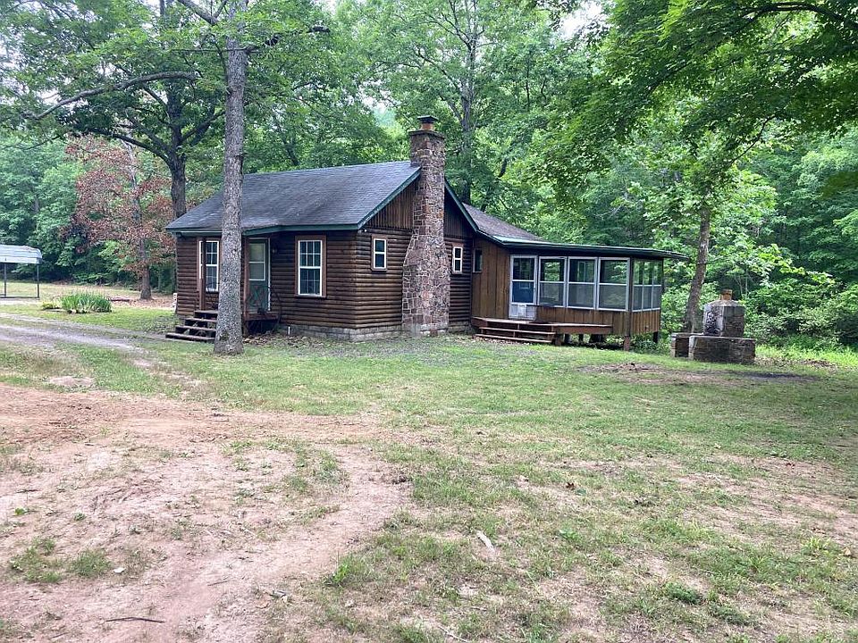 <p>A roughly 1100 square foot cabin sits along the banks of the creek</p>