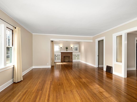 Expansive Living/Entry Room with beautiful, renewed hardwood floors, fresh paint, drapery provided. The full length of the Living/Entry is 28'.