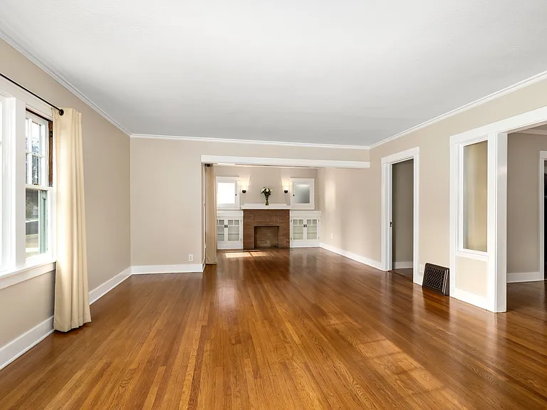 Expansive Living/Entry Room with beautiful, renewed hardwood floors, fresh paint, drapery provided. The full length of the Living/Entry is 28'.