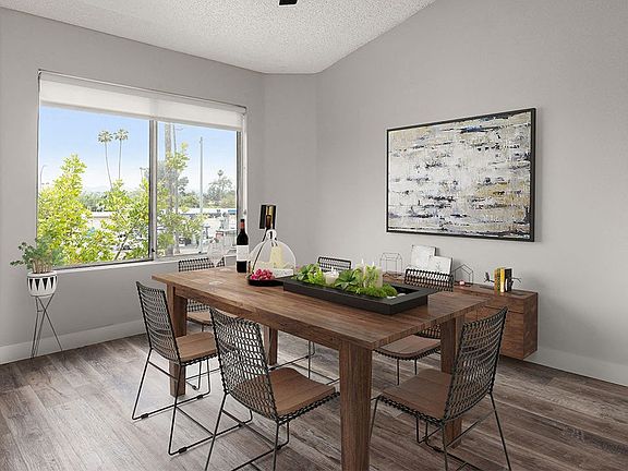 Hardwood floored dining room with view of grassy courtyard.