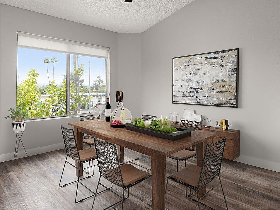 Hardwood floored dining room with view of grassy courtyard.
