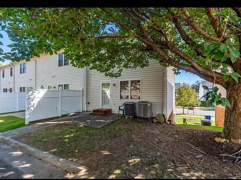 Rear view. 1 parking spot. Private patio with direct access to kitchen/dining area.