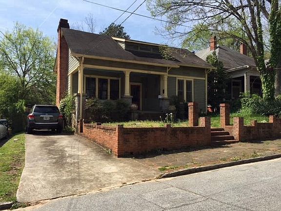 Front of house with driveway and street parking
