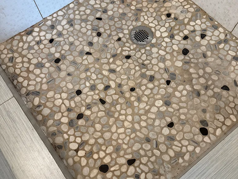 Stone floor shower en suite master bath.