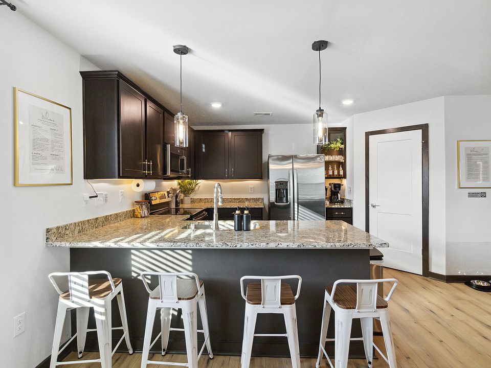 Enjoy a blend of comfort and modern elegance in this beautiful kitchen space with barstools to stay connected with your group. Whether you're cooking a gourmet meal or sipping morning coffee, you'll feel right at ease.