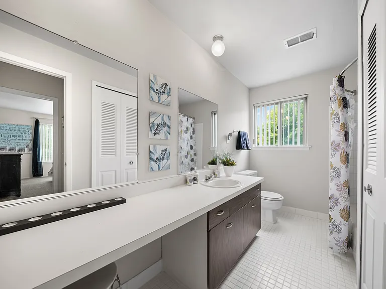 Elevated bathroom with ample storage space at Knottingham Apartments in Clinton Township, MI.