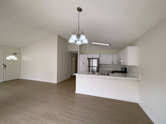 Spacious and bright living room with high ceilings.