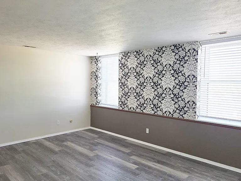Bedroom with a accent wall at Francis Villas.
