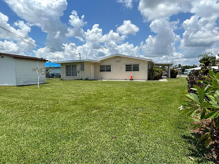 Standing at the corner of the property looking to the back of the home.