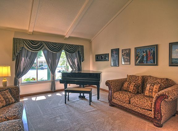 Formal living room with vaulted ceiling