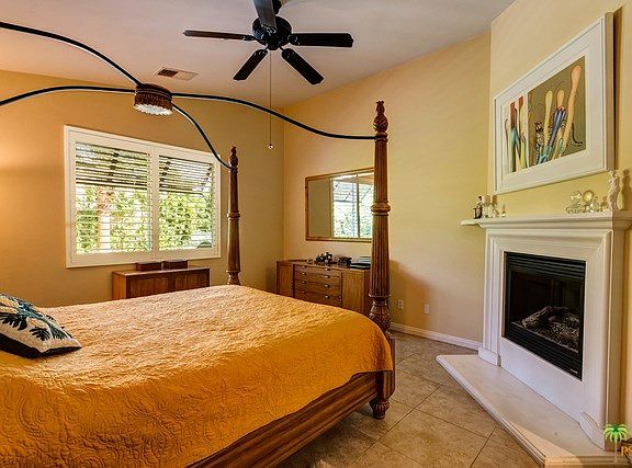 Master bedroom with fireplace and high ceilings