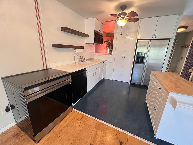 Kitchen with stainless steel appliances and glass cooktop