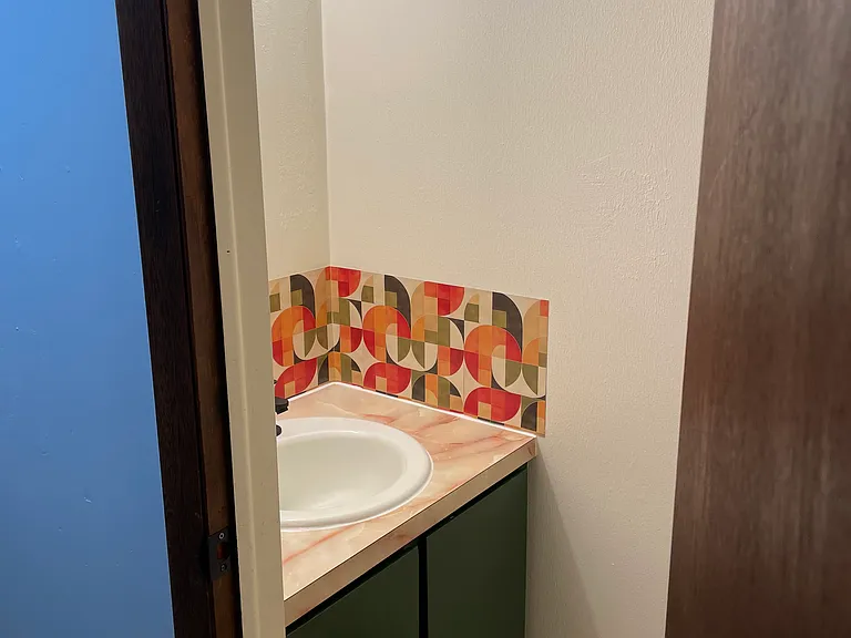 Half bathroom off smaller bedroom.