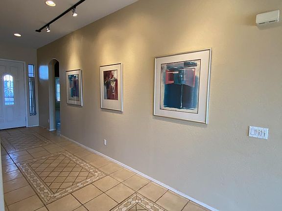 Upgraded, custom tile work throughout property. Easy to keep clean and attractive! Hallway features overhead spotlights to showcase your favorite pictures, accomplishments and art! Picture taken November 13, 2023.