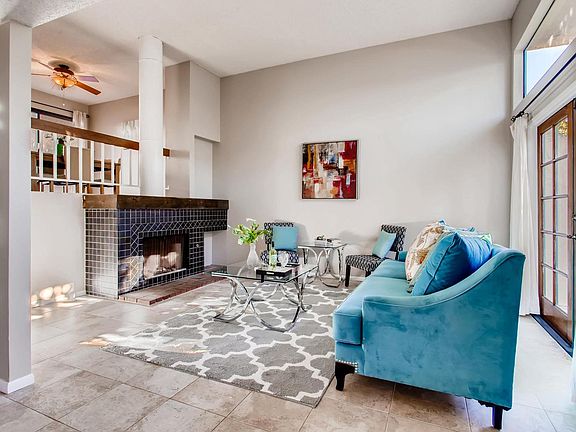 Bright Spacious open living room with tall ceiling, huge window, french doors and coat closet hidden behind wall when enter front door.