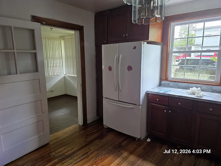Kitchen leading to entrance foyer