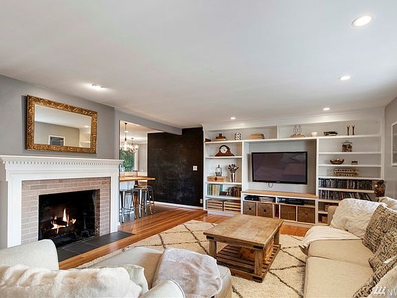 Living room with wood burning fireplace. 