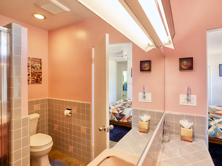 Mirror reflection of master bathroom.