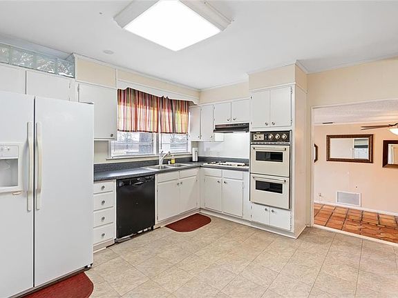 View of kitchen looking into the family room/den