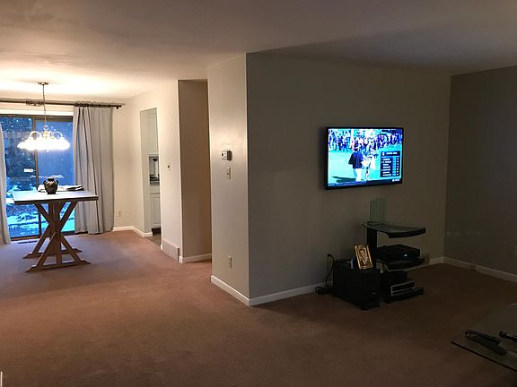 Open and spacious dining room living room with slider to pat