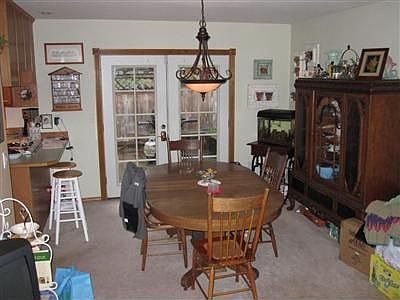 Dining room includes plenty of space and french doors leading to the private deck.