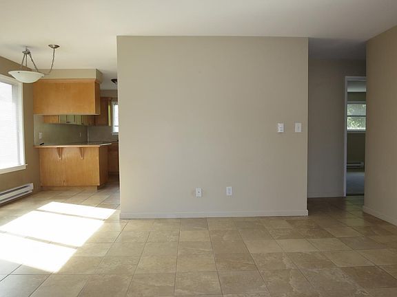Living area facing kitchen and hall to upstairs beds and bat
