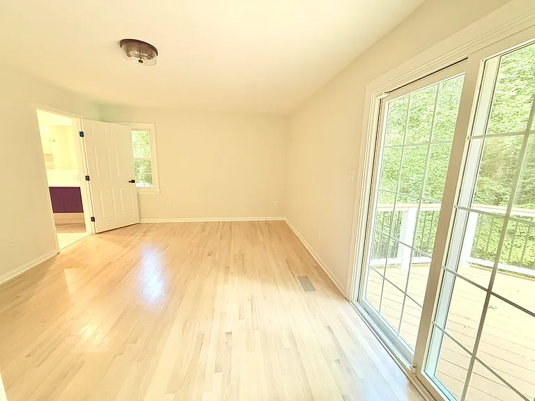 Main floor master overlooking the deck with private en suite bath and walk-in closet