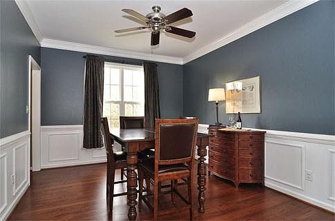 Dining room with hardwood floors and beautiful millwork.