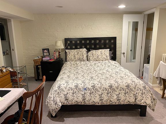 English basement bedroom with attached full bathroom and private entrance.