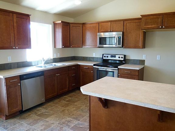 Kitchen with Stainless Applances and roo