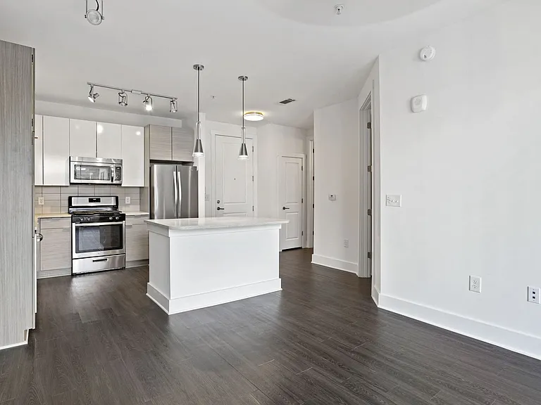 Grey toned luxury vinyl plank flooring in select units