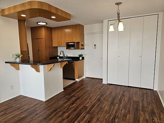 Open concept kitchen with bamboo cabinets, dining area & extra-large pantry.