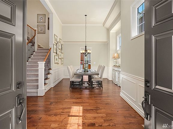 Stunning entry with beautiful hardwoods and stairway.