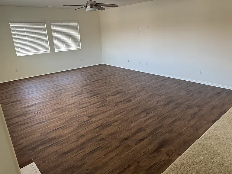 View of large upstairs bonus room with new upgraded flooring and ceiling fan/light.

New upgraded LVP flooring. throughout