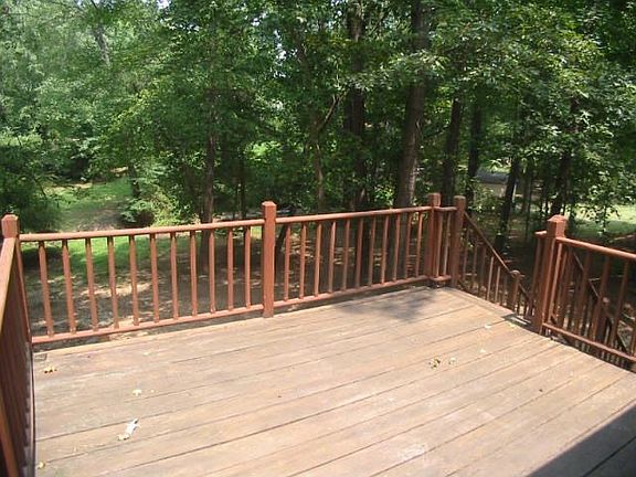 Deck overlooks large wooded yard