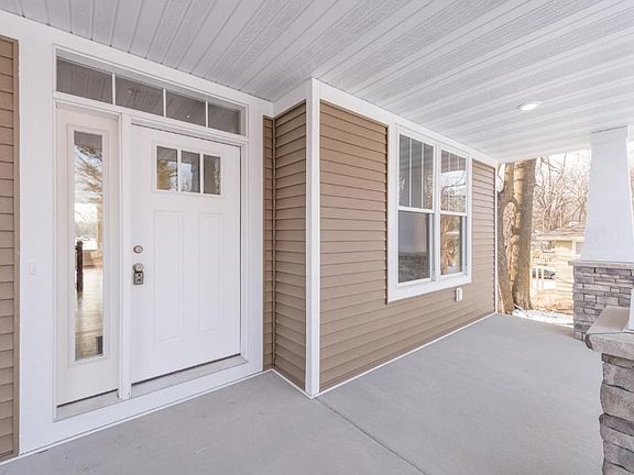 Concrete front porch is great for relaxation. Stone facade on the pillars add a custom look to the exterior.