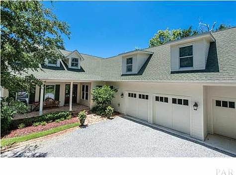 Beautiful coastal home, complete with dormers, covered front and back porches and 3 car garage