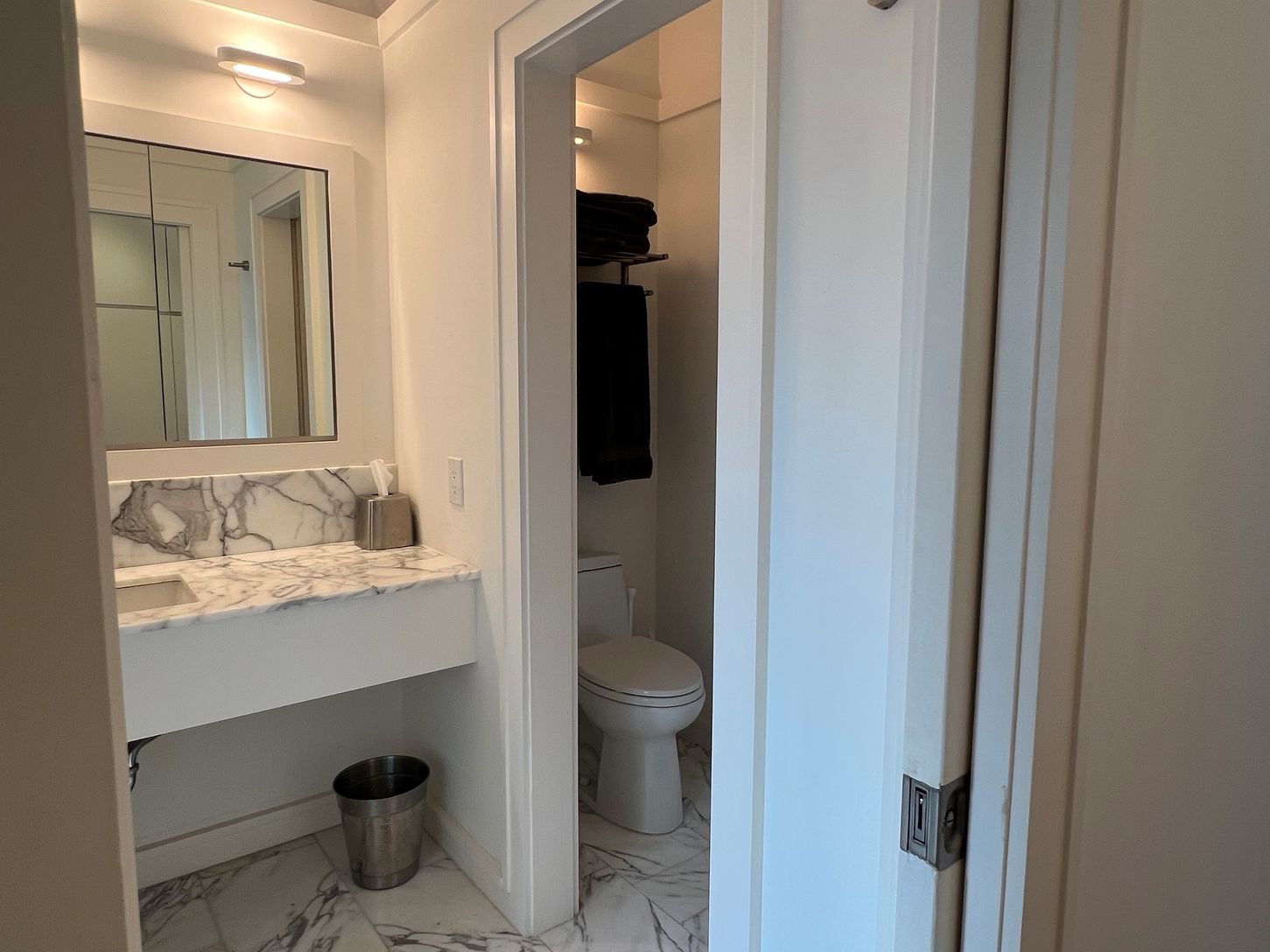 Primary en-suite Carrera marble bathroom