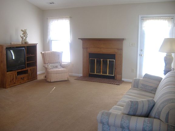 Family Room w/ Fireplace and Vaulted Ceiling