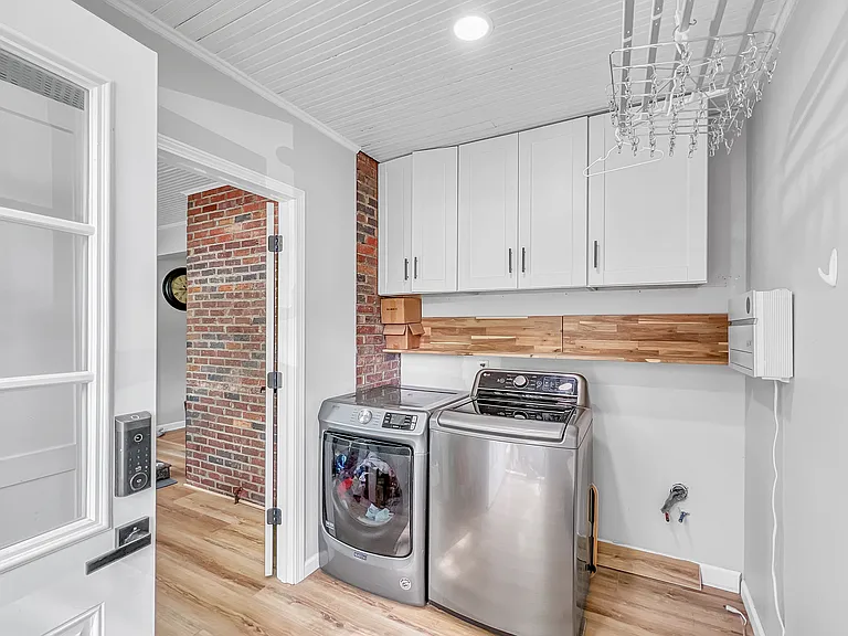 Laundry room is on the main floor and doubles as a mud room off of the large back porch. Also includes ample storage cabinets.