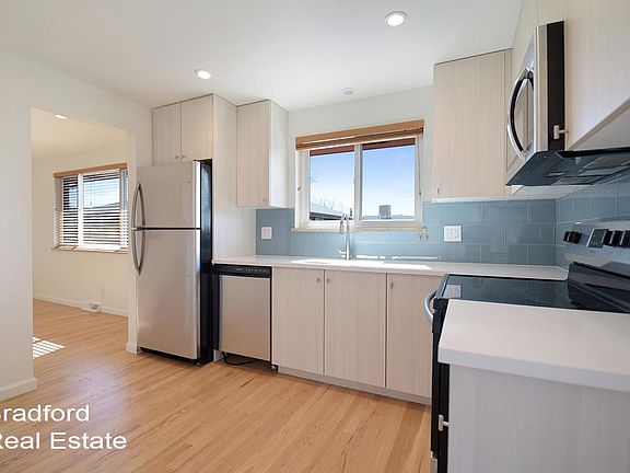 Updated kitchen with stainless appliances and quartz counter tops with lots of natural light