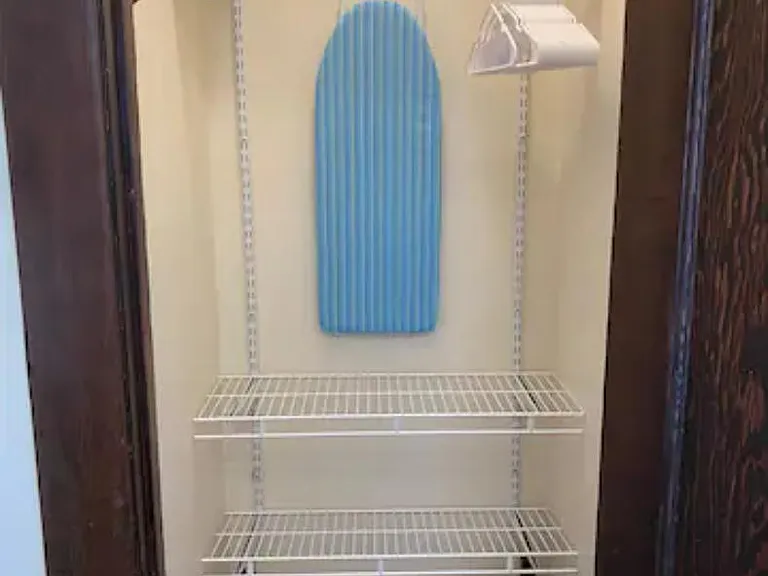 Walk in closet with iron & ironing board