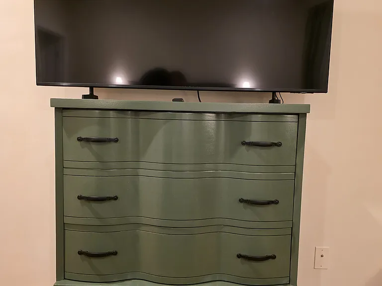vintage refinished dresser to match decor. 55" smart TV. very spacious and well appointed master bedroom