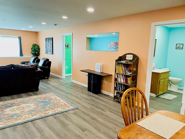 View from kitchen of living room and guest bathroom.