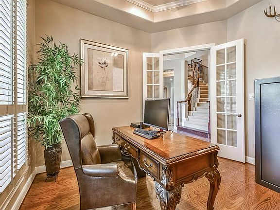 SPACIOUS OFFICE WITH BEAUTIFUL WOOD FLOORS, PLANTATION SHUTTERS, AND GORGEOUS FRENCH DOORS ARE PERFECT FOR WORKING AT HOME OR JU