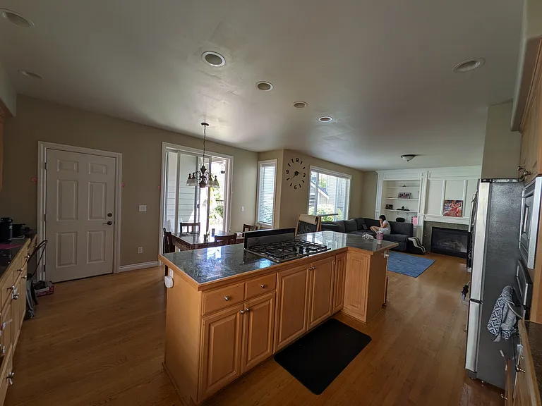 Open kitchen with granite counter tops, and space for breakfast table.
