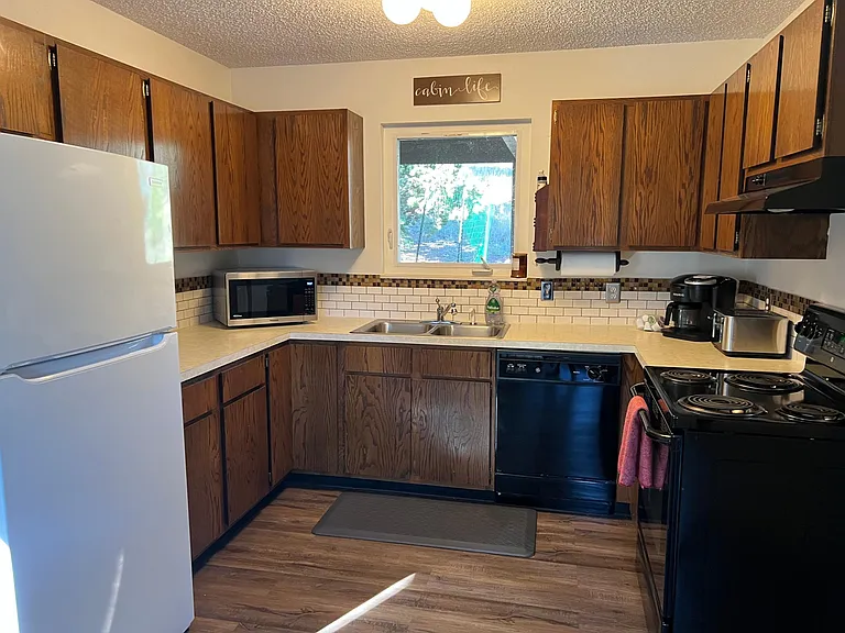 Full kitchen with oven/range, microwave, dishwasher, refrigerator/freezer, coffee pot and toaster.
