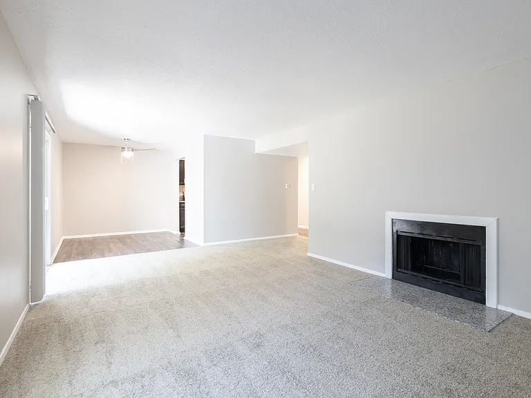 Dining and Living Room with a Fireplace in the Two Bedroom Two Bath Apartment at Woodbridge Bloomington