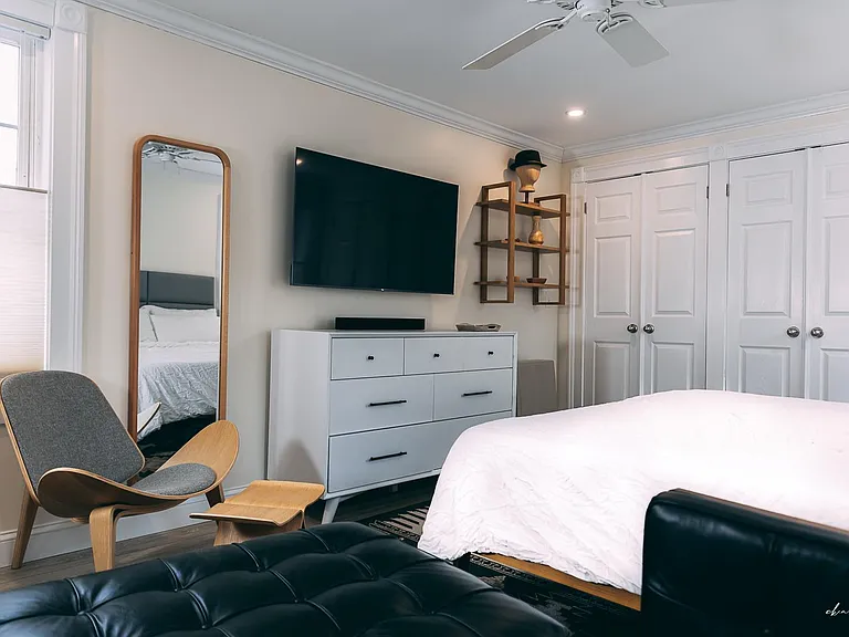 The room has a 65 inch television.