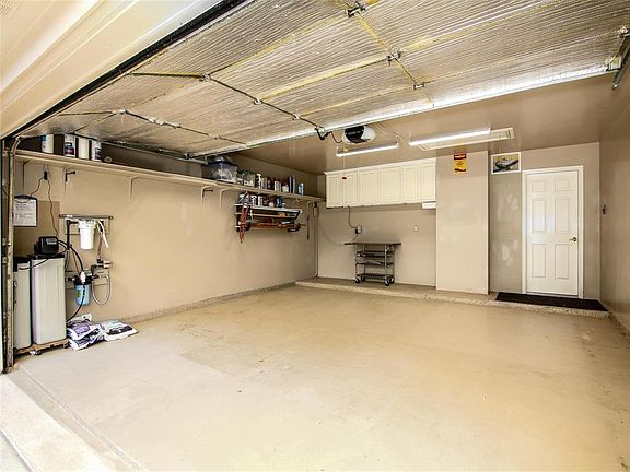 Garage, finished floor, cabinets, shelving, soft wter system